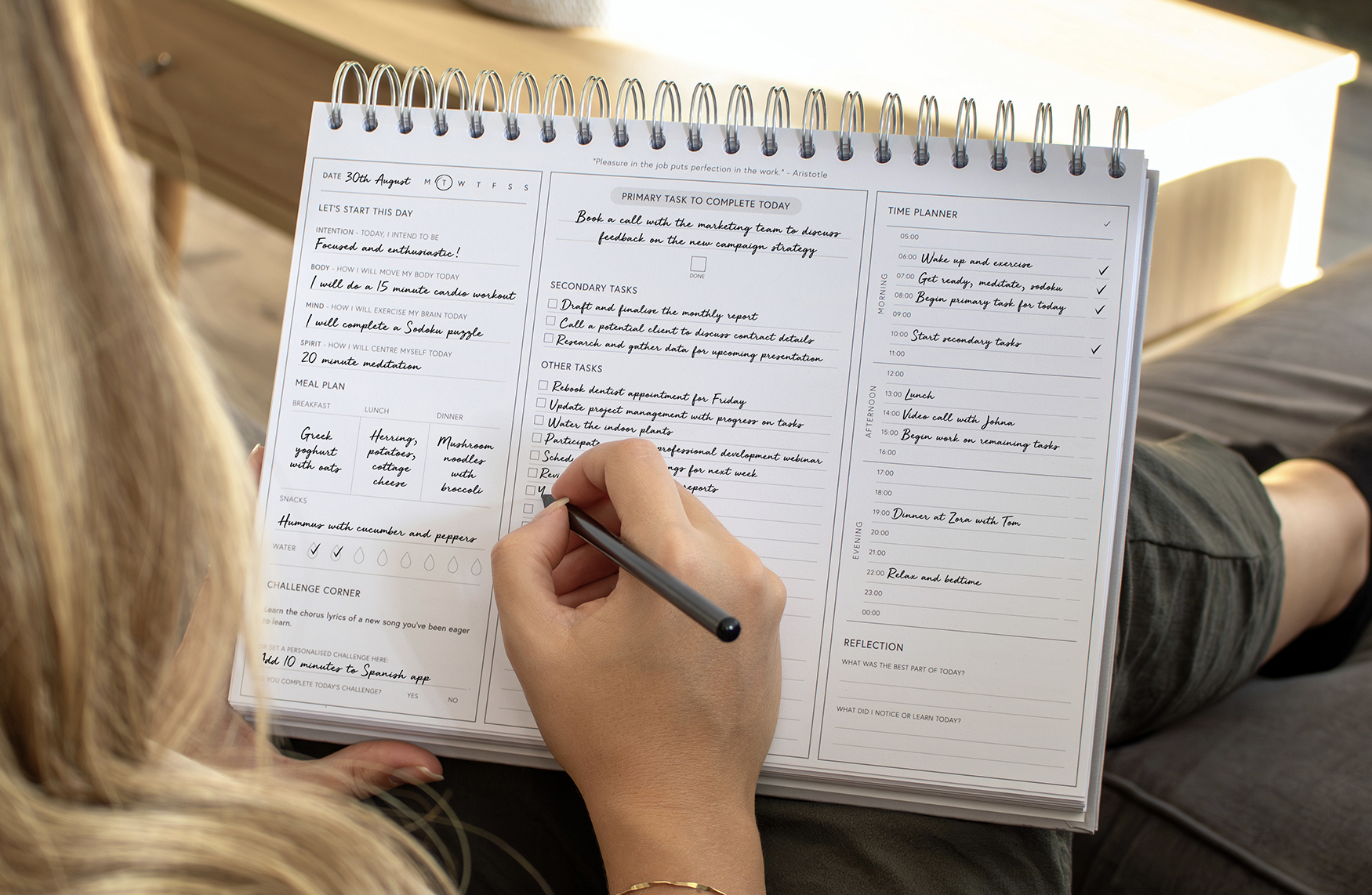 Filled Out Light Linen Daily Productivity Planner On a Sofa